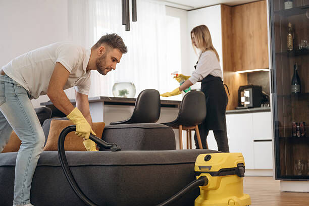 Image of a team cleaning high fixtures.